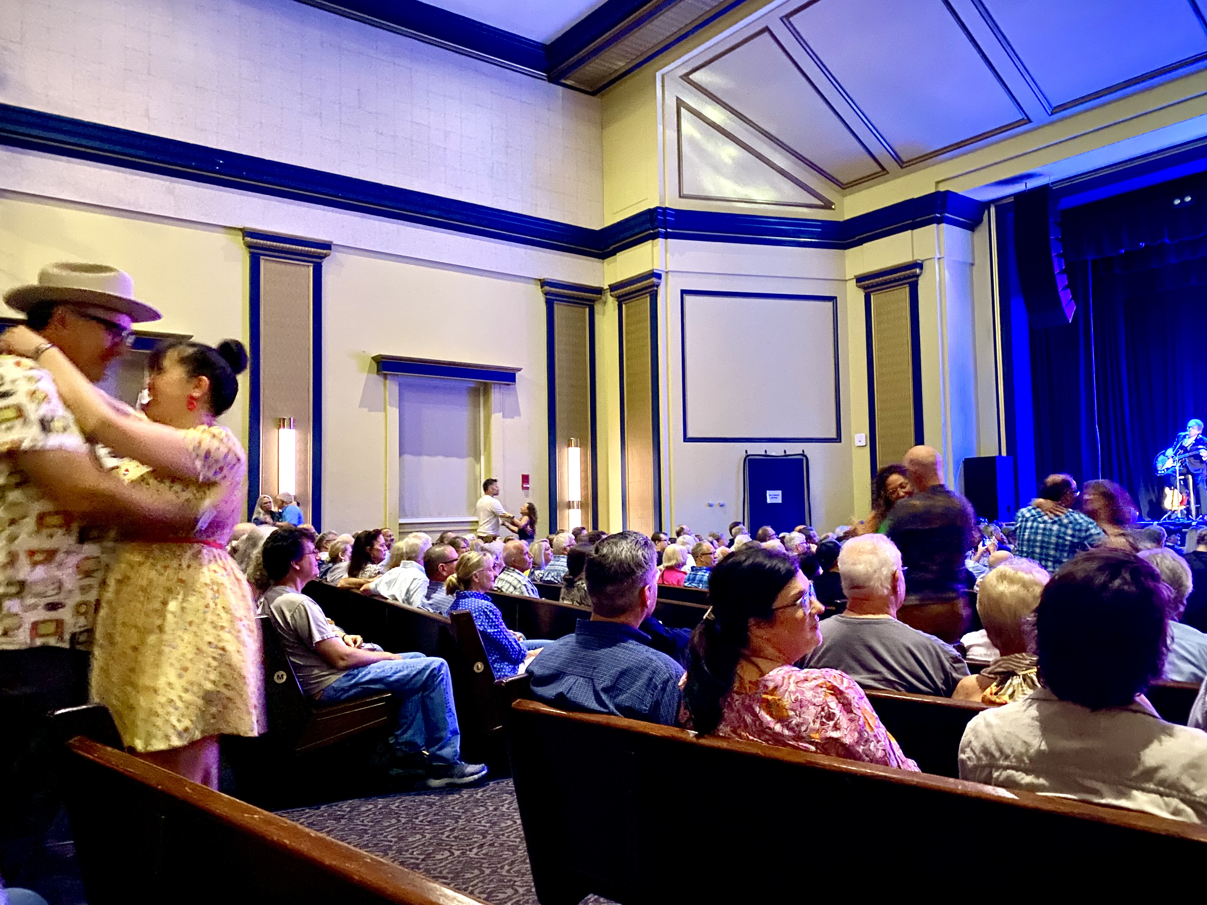 Audience dancing in the aisles while Chris Isaak sings a love song.